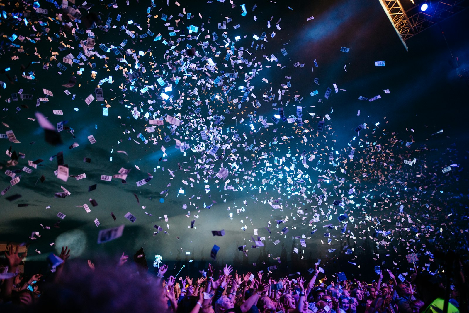 Confetti falling over a crowd at a live event moment