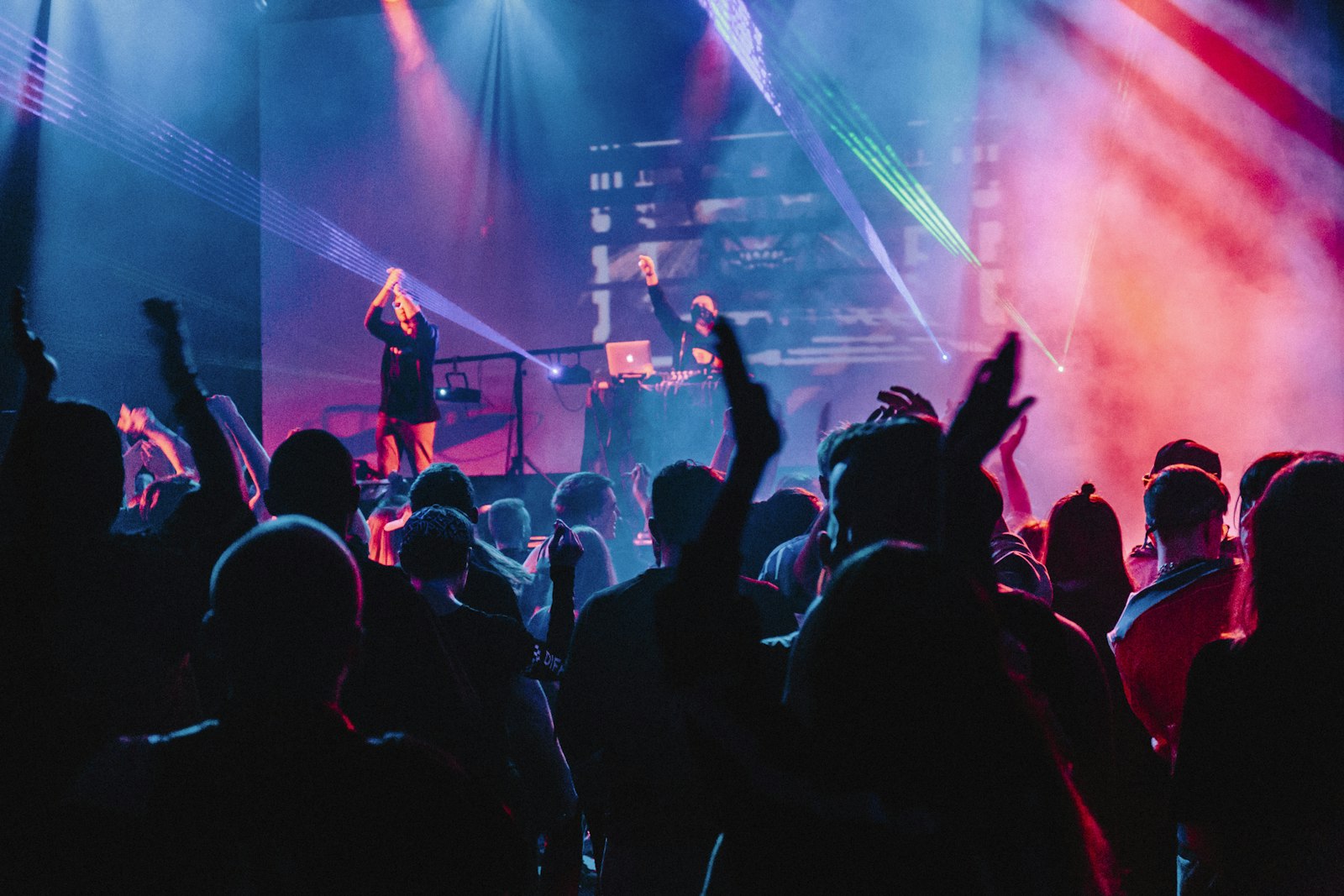 Stage with laser beams and projection screens at a live show